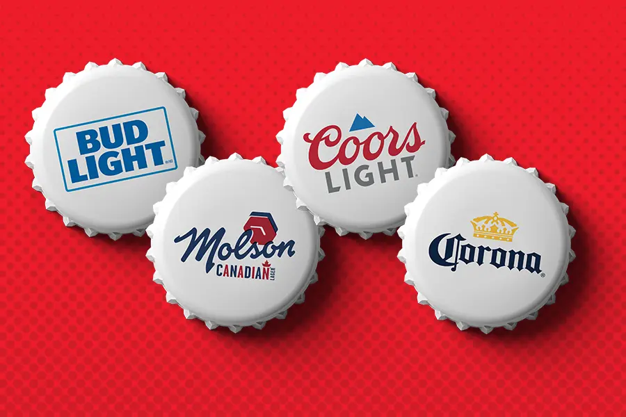 Collection of beer bottle caps on red background.